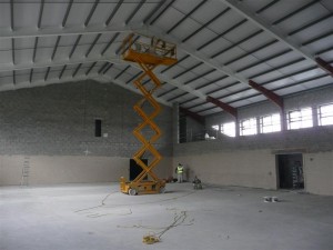 Painting of steel roof of a warehouse using mobile elevated platform in County Kerry by Total Paintworks Ltd., Ireland